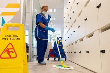 Janitor cleans the floor