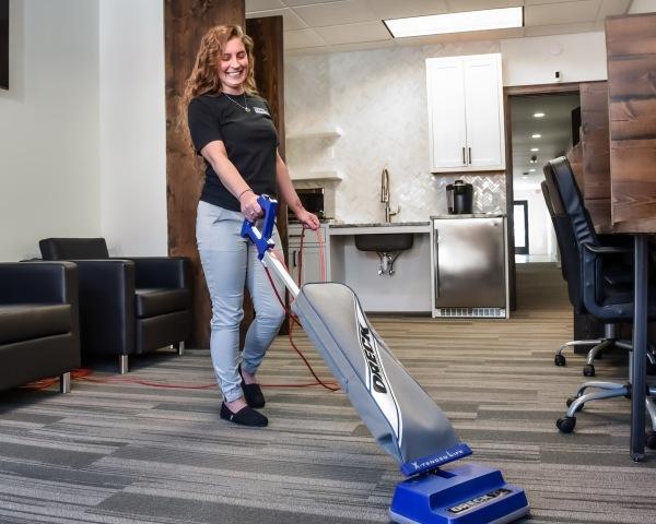 A woman executing professional carpet cleaning services in Easpointe, MI. Air duct cleaning is also available.